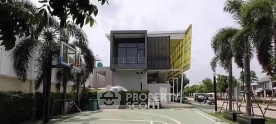 Modern architectural home with basketball court and lush greenery