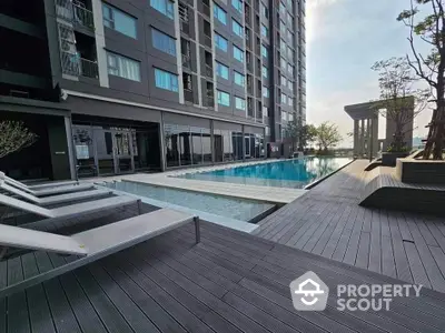 Luxurious high-rise apartment with stunning poolside view and modern amenities.