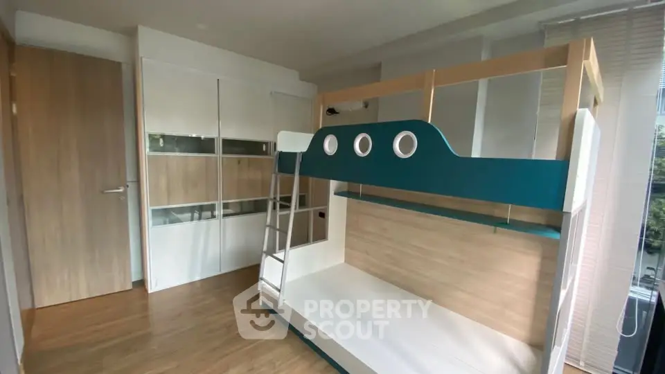 Modern bedroom with stylish bunk bed and ample storage space