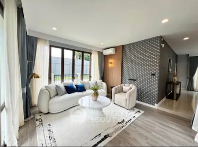 Modern living room with stylish decor, large windows, and elegant furniture in a bright, airy space.