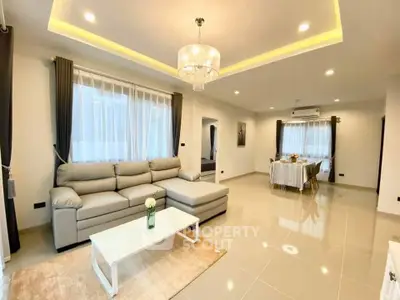 Spacious modern living room with elegant lighting and cozy dining area