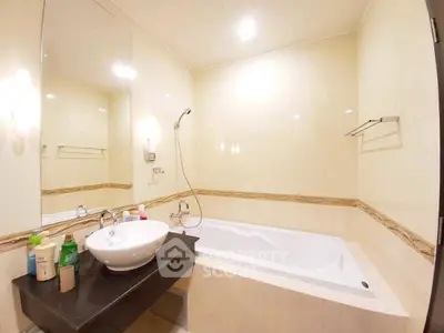 Spacious bathroom with modern bathtub and sleek sink design