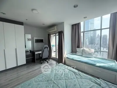 Modern bedroom with city view, featuring large windows, stylish furniture, and natural light.