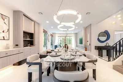 Luxurious dining room with modern chandelier and elegant table setting in a contemporary home.