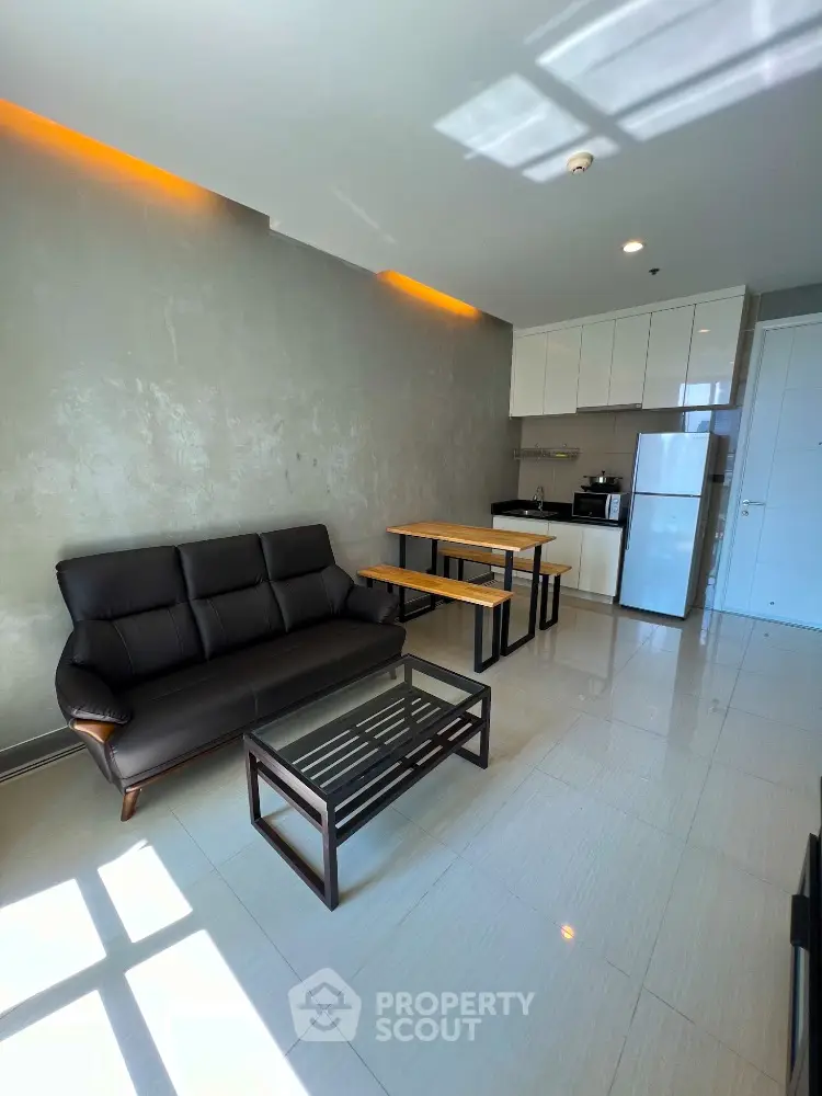 Modern open-layout living room with sleek kitchen and stylish furniture