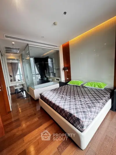Luxurious bedroom with modern design and wooden flooring in high-rise apartment