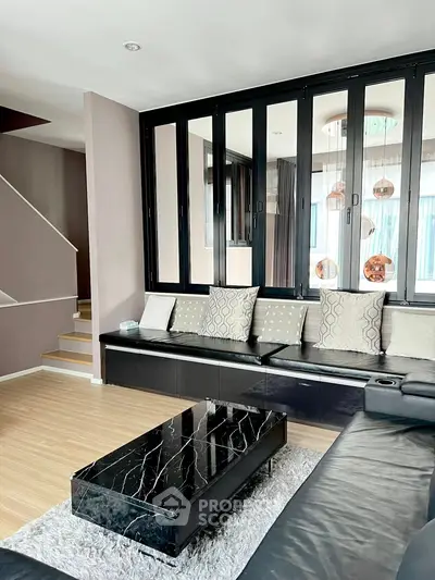 Stylish modern living room with sleek black furniture and elegant decor