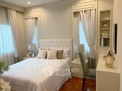 Elegant bedroom with plush bedding and stylish decor in a cozy real estate listing.