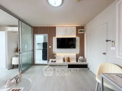 Modern living room with sleek design and open layout, featuring a wall-mounted TV and stylish decor.