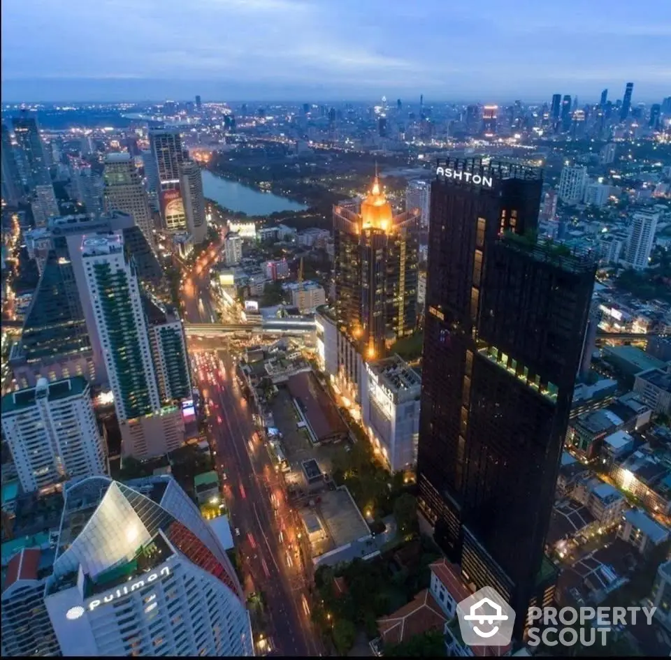 Stunning aerial view of city skyline with illuminated skyscrapers and bustling streets at dusk.