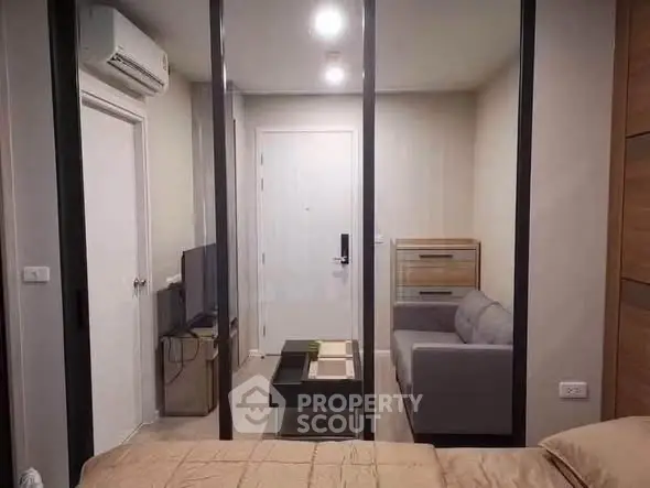 Modern living room with glass partition and cozy sofa in stylish apartment