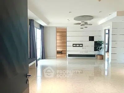 Spacious modern living room with elegant lighting and large windows