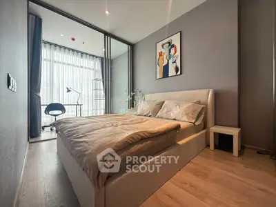Modern bedroom with stylish decor and large window for natural light