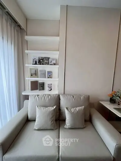 Stylish modern living room with elegant beige sofa and decorative shelving