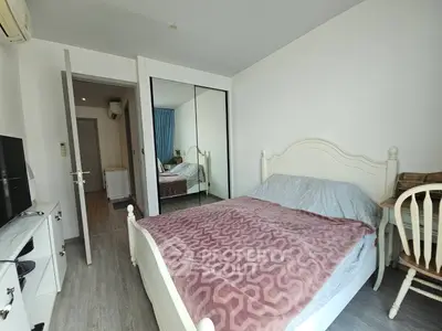Cozy bedroom with mirrored wardrobe and elegant white bed frame