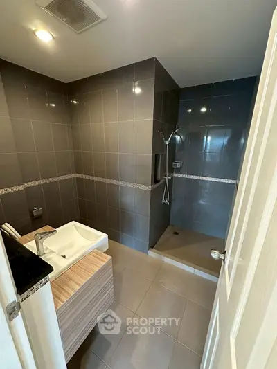 Modern bathroom with sleek tiles and walk-in shower