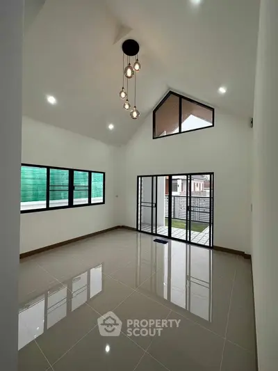 Spacious modern living room with high ceiling and large windows