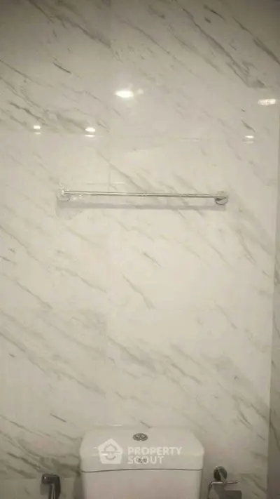Elegant bathroom with marble wall and modern fixtures