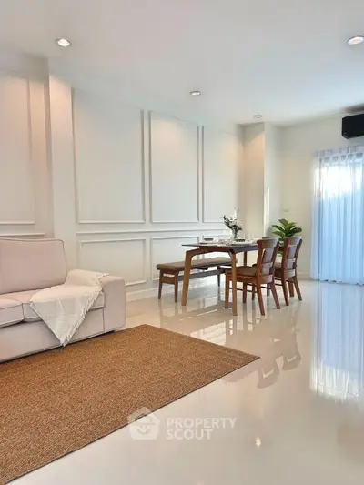 Modern living room with elegant dining area and stylish decor