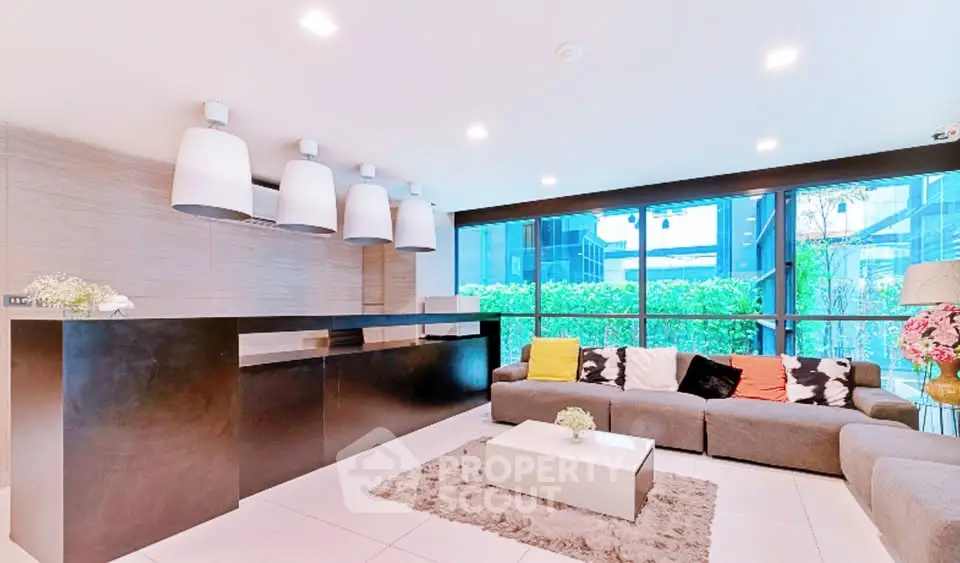 Modern living room with sleek design and large windows offering natural light