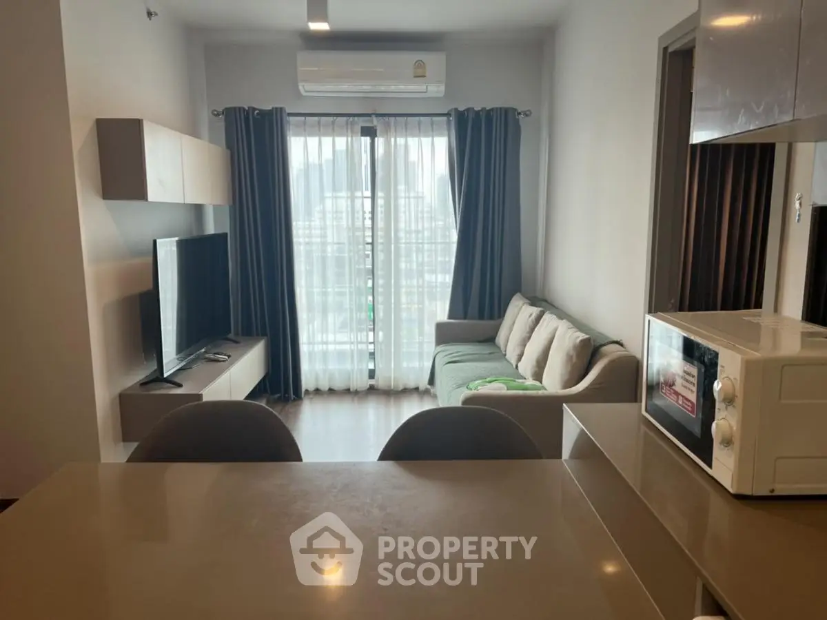 Modern living room with city view, featuring sleek furniture and open layout for comfortable urban living.