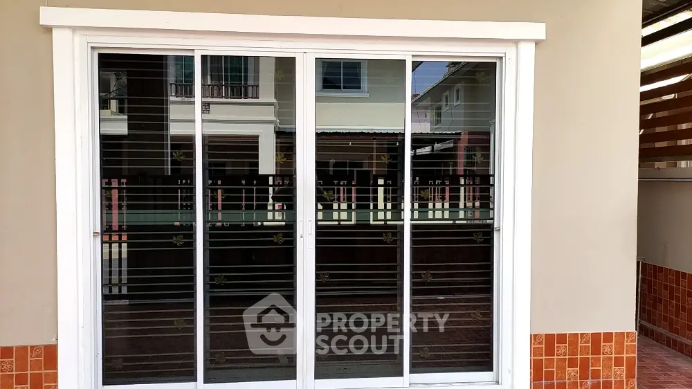 Modern sliding glass door with reflective exterior view