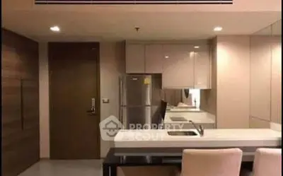 Modern kitchen with sleek cabinetry and stainless steel appliances in a stylish apartment.