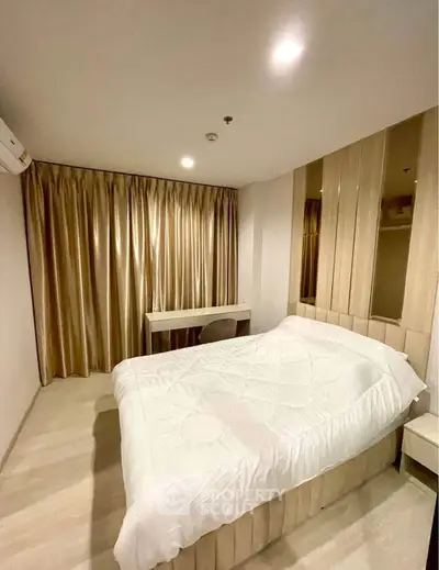 Cozy bedroom with elegant curtains and modern decor in a stylish apartment.