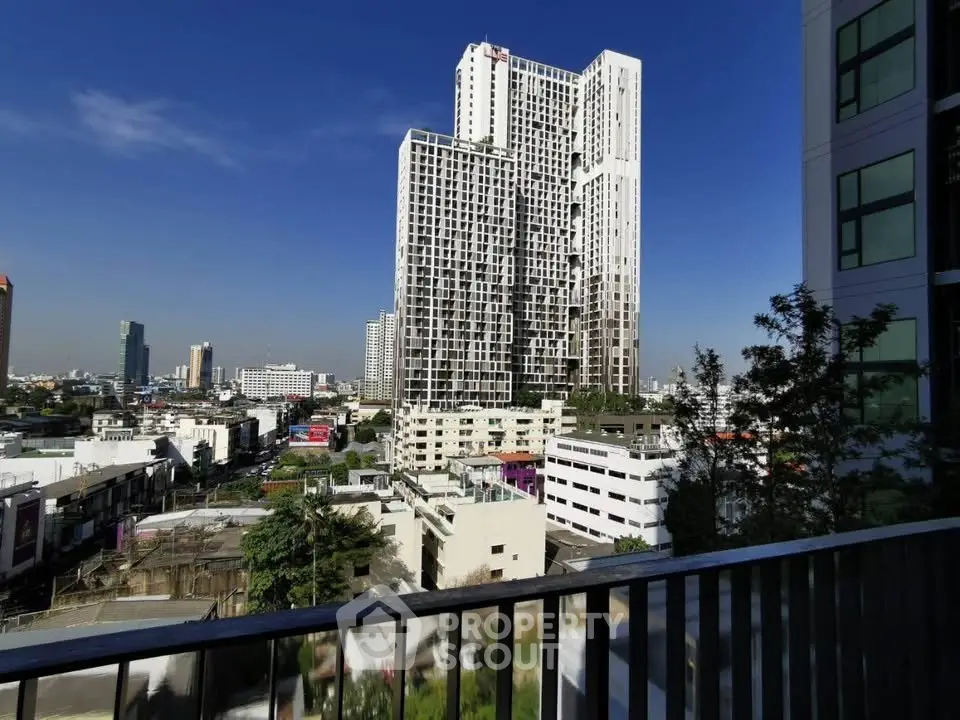 Stunning cityscape view from a high-rise balcony with modern architecture.