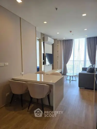 Modern living room with stylish furniture and large windows offering natural light.