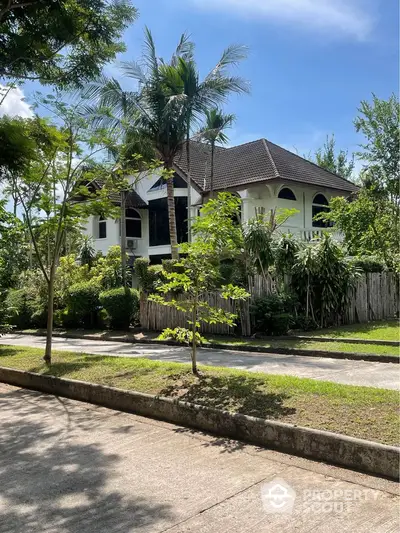 Stunning tropical villa with lush garden and modern architecture in serene neighborhood.