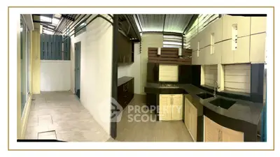 Spacious kitchen with modern cabinetry and open layout, perfect for culinary enthusiasts.