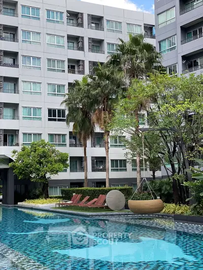 Luxurious apartment complex with a stunning pool and lush greenery, perfect for modern living.