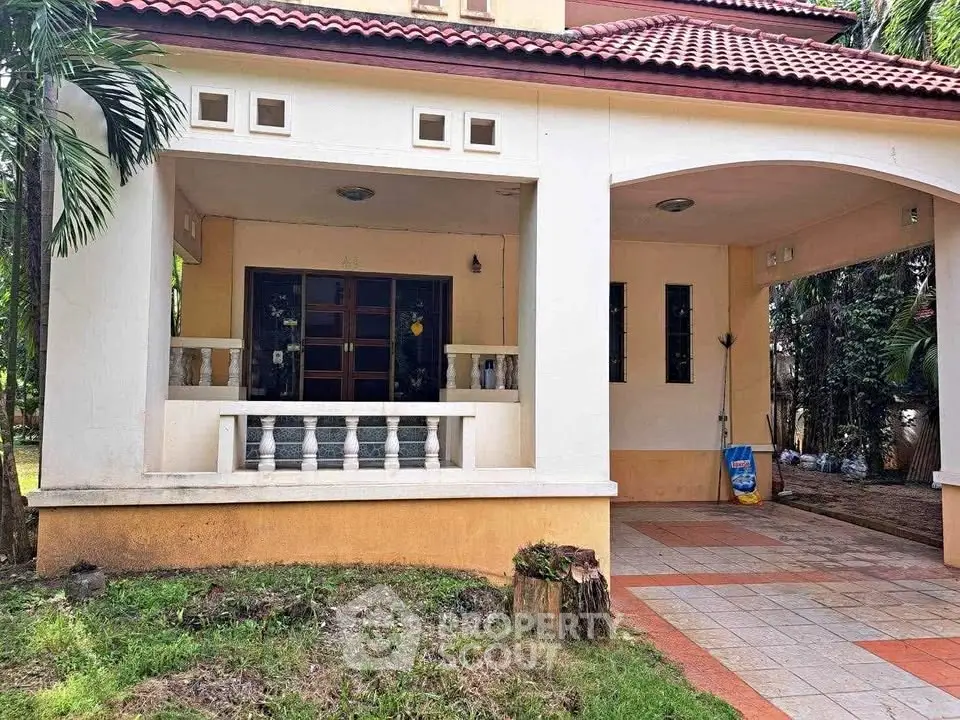 Charming suburban home with spacious covered patio and lush greenery