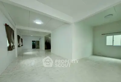 Spacious open-plan interior with tiled flooring and natural light, ideal for versatile living arrangements.