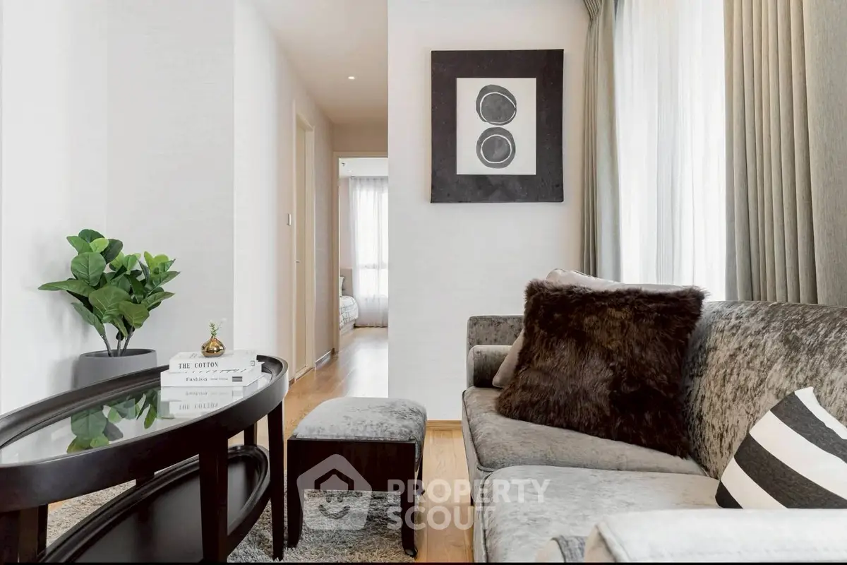 Elegant living room with plush sofa, stylish decor, and natural light.