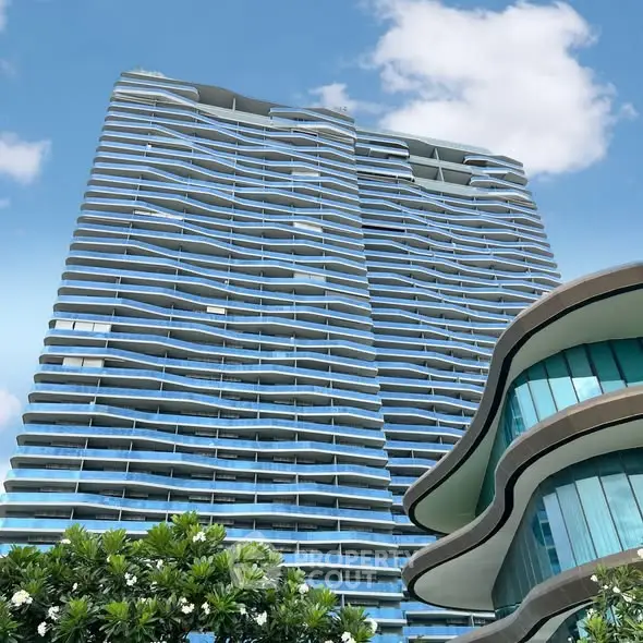 Stunning modern high-rise building with unique architectural design and lush greenery.