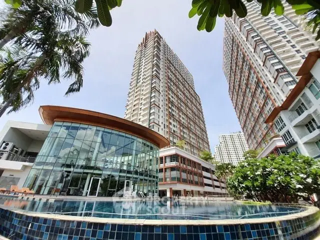 Stunning modern apartment complex with pool and lush greenery