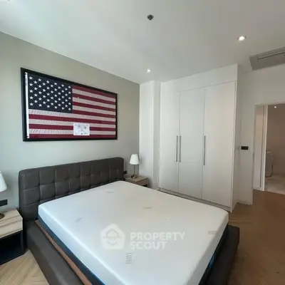 Modern bedroom with American flag decor and sleek furniture