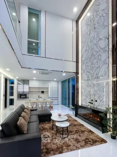Luxurious modern living room with high ceilings and elegant marble wall feature