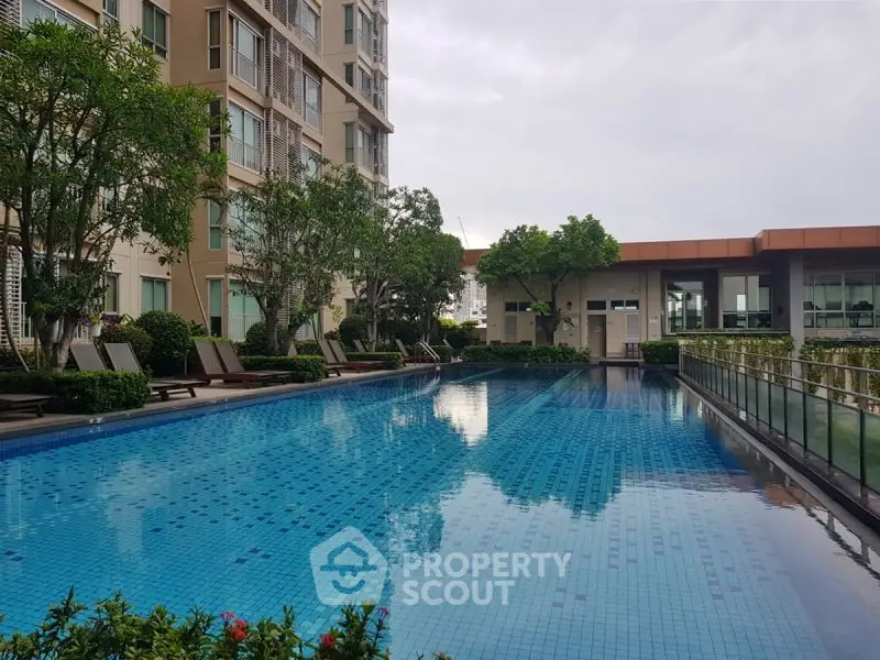 Luxurious apartment complex with stunning pool and lush greenery