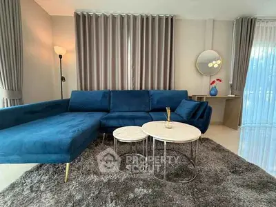 Luxurious living room with plush blue sofa and elegant decor