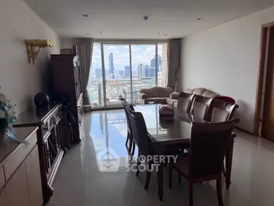 Spacious living room with city view and elegant dining set