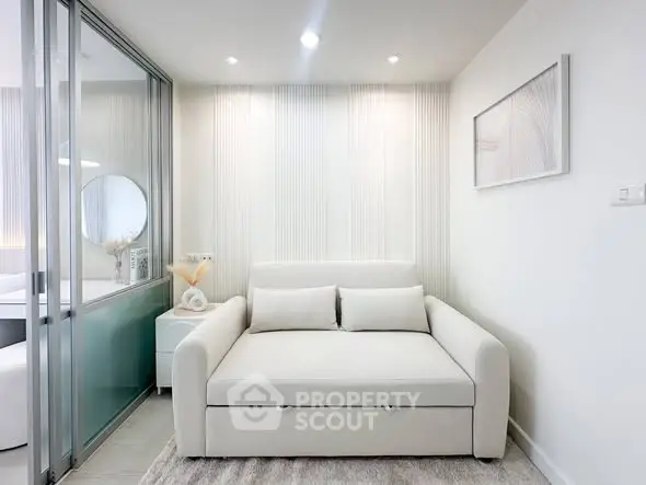 Modern living room with sleek white sofa and minimalist decor
