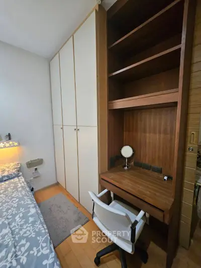 Cozy bedroom with built-in wardrobe and study nook, perfect for modern living.