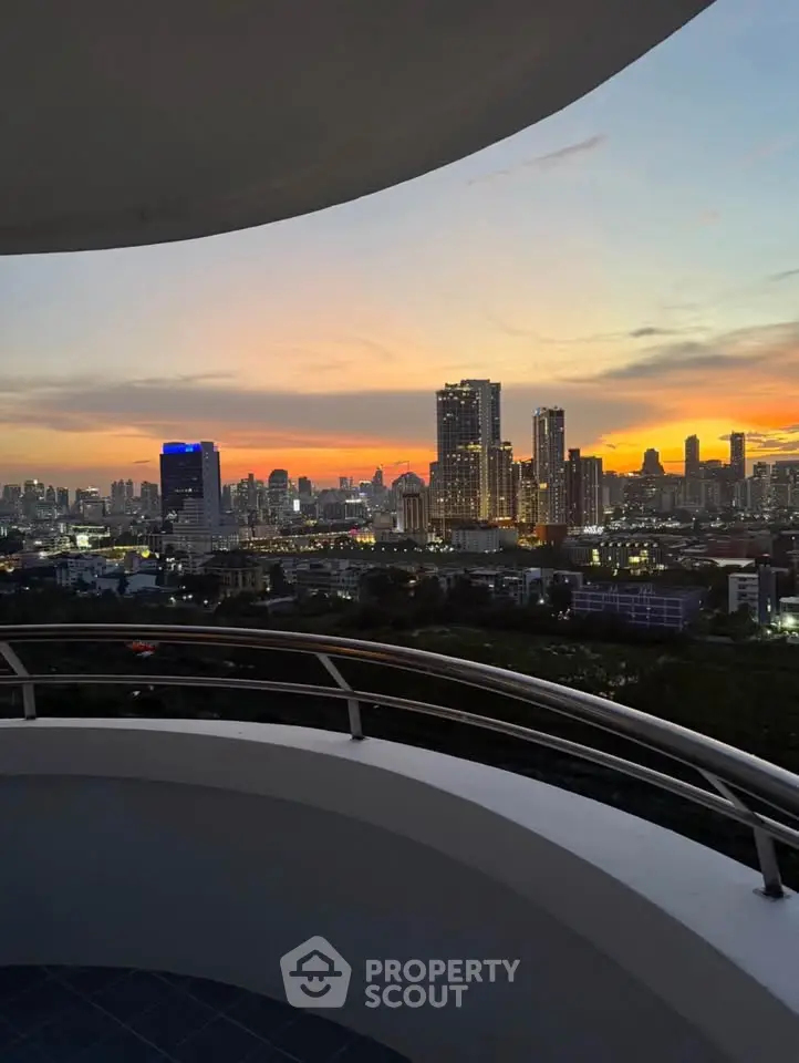 Stunning city skyline view from a modern balcony at sunset, perfect for urban living enthusiasts.
