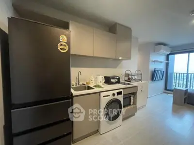 Modern kitchen with sleek appliances and open layout in stylish apartment.