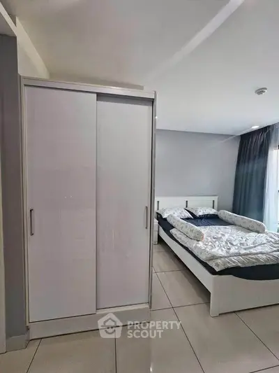 Modern bedroom with sleek wardrobe and cozy bed in a stylish apartment.