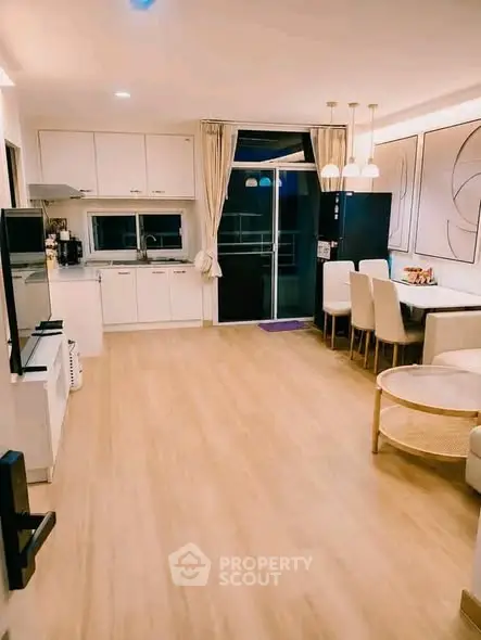 Spacious open-layout kitchen and dining area with modern decor and ample natural light.