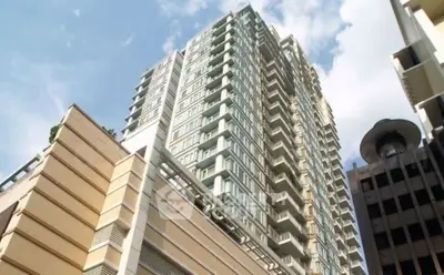 Stunning high-rise building with modern architecture and expansive windows in urban setting.